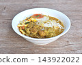 rice noodles in coconut milk curry soup with beef meat topping slice creamy     boiled egg yolk halal food on bowl 143922022