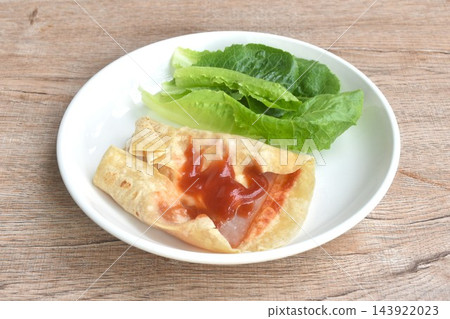berrito stuffed slice ham pork with cheese dressing ketchup sauce eat couple fresh cos lettuce vegetable salac on plate 143922023