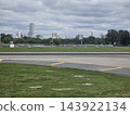 Buenos Aires, Argentina - October 11, 2026: airport runway and city buildings beyond the airfield 143922134