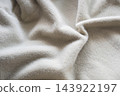 Soft gray fur wool blanket close-up showing plush fur pile. Delicate texture and gentle folds for fashion winter or autumn clothes. Evokes warmth, comfort and hygge for interior and home decor, fashio 143922197
