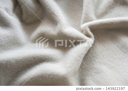 Soft gray fur wool blanket close-up showing plush fur pile. Delicate texture and gentle folds for fashion winter or autumn clothes. Evokes warmth, comfort and hygge for interior and home decor, fashio 143922197