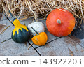Orange, green, yellow fresh pumpkins on the street. Autumn nature background for Halloween decoration or cookin. Vegetables market. 143922203