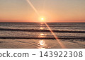 Walking near beautiful sea in the evening and view on the sunlight. Sunset on the beach in summer time. Vacation. Nature background. 143922308