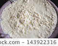Fresh homemade ricotta curds resting in cheesecloth as whey drains, showcasing creamy texture and natural dairy goodness. Rustic artisanal cheese preparation ideal for cooking, baking, and food photog 143922316