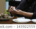 A woman making dumplings 143922559