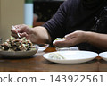 A woman making dumplings 143922561
