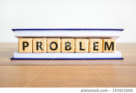 Problem word symbol. Concept word Problem on beautiful wooden blocks in book. Beautiful wooden table white background. Business problem word concept. Copy space. 143923000