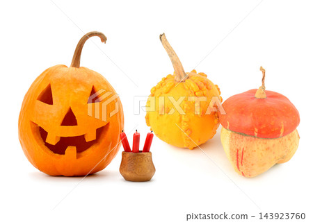 Horizontal view of carved Halloween jack-o-lantern pumpkin with decorative gourds and red candles isolated on white background Horizontal view of carved Halloween jack-o-lantern pumpkin with decorative gourds and red candles isolated on white background 143923760