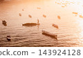 Ocean with boats in Lembongan island in Indonesia. Algae farm with morning warm sunlight 143924128