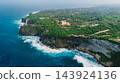 Drone view of coastline with rocky cliffs, ocean with waves in Uluwatu, Bali 143924136