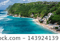 Drone view of turquoise beach and rolling waves along tropical shore 143924139