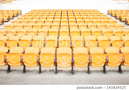 Empty Orange Stadium Seats in Bright Sports Arena 143924525