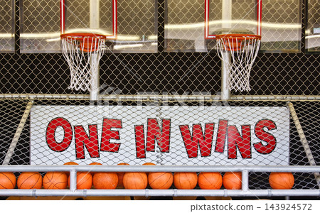 Basketball Arcade Game Hoops Behind Chain Link Fence Basketball Arcade Game Hoops Behind Chain Link Fence 143924572