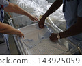 Nurses preparing a hospital cot for a newborn baby 143925059