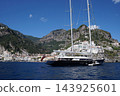 View of beautiful Amalfi town, Campania, Italy. Amalfi coast is most popular travel and holiday destination in Europe. Amalfi cityscape on coast line of mediterranean sea - big yacht 143925601