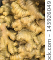 Fresh ginger roots piled in a golden market display 143926049