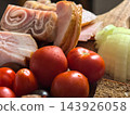 Rustic pork and ripe tomatoes gathered for a hearty meal 143926058
