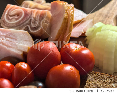Rustic pork and ripe tomatoes gathered for a hearty meal 143926058