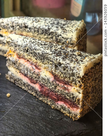 Layered berry cake dusted with dark poppy seeds Layered berry cake dusted with dark poppy seeds 143926059
