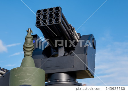Modern military rocket launcher mounted against clear blue sky Modern military rocket launcher mounted against clear blue sky 143927580