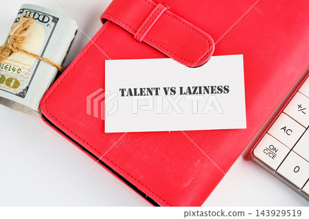 A card reading talent versus laziness rests on a red planner beside cash and a calculator on a desk, with no time of day shown A card reading talent versus laziness rests on a red planner beside cash and a calculator on a desk, with no time of day shown 143929519