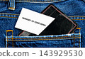 A white card reading Mindset vs confusion rests in the back pocket of blue jeans, shown in a close view with no time or place specified 143929530