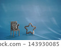 Miniature chair and star symbols set on blue background 143930085