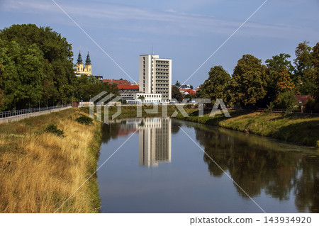 Nitra River with Modern Building Reflection and Tree Lined Banks in Slovakia 143934920