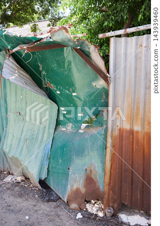 Bent Rusty Metal Fence Damaged by Tropical Weather Bent Rusty Metal Fence Damaged by Tropical Weather 143939460