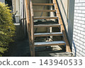 Outdoor steel staircase and handrail of a house with peeling paint. 143940533