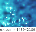 A vibrant abstract background featuring soft, out-of-focus blue light orbs and shimmering particles, creating a dreamy and ethereal atmosphere for creative projects. 143942189