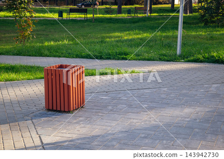 Wooden sorting trash bin in public park on autumn day symbolizing ecology and zero waste lifestyle copy space Wooden sorting trash bin in public park on autumn day symbolizing ecology and zero waste lifestyle copy space 143942730
