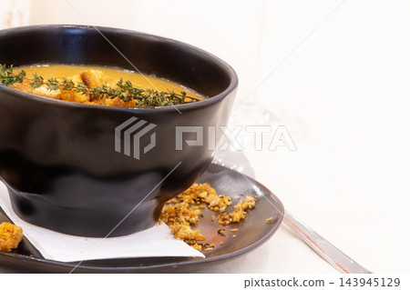 Cream soup with croutons and thyme Cream soup with croutons and thyme 143945129