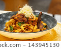 pasta with mushrooms and grated yellow cheese 143945130