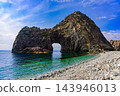 A majestic early spring scene captured from Senkankado Beach in mid-March, showing the massive, strangely shaped rock formation of Senkankado jutting out into the cobalt blue sea. A majestic early spring scene captured from Senkankado Beach in mid-March, showing the massive, strangely shaped rock formation of Senkankado jutting out into the cobalt blue sea. 143946013