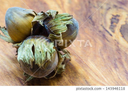 Hazelnuts cluster filbert nuts in the hard shell. Hazelnuts cluster filbert nuts in the hard shell. 143946118