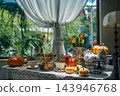 autumn harvest table setting with orange pumpkins near bright window, cozy fall indoor halloween arrangement featuring ceramic chicken candlestick 143946768