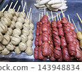 Sausage meatball skewer assortment displayed together on metal tray 143948834