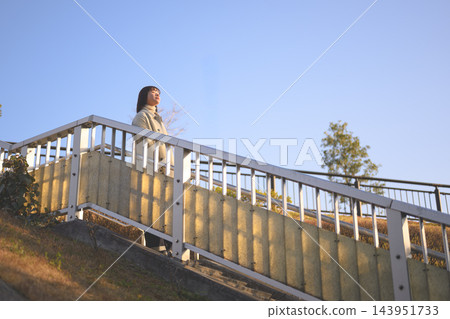 一位女子拾級而上,仰望天空。 一位女子拾級而上,仰望天空。 143951733