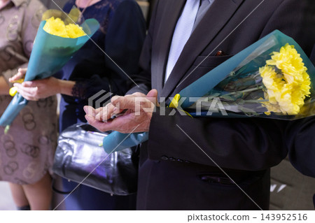 A crowd gathers with flowers in their hands to celebrate a local event in A crowd gathers with flowers in their hands to celebrate a local event in 143952516