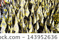 Many small flags of Ukraine with names of the dead war against russia. Memorial of the fallen soldiers, children, women in the center of Kyiv. Concept of tragedy and misfortune. Closeup 143952636