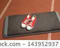 Red sneakers on gym mat in sports facility during training session 143952937