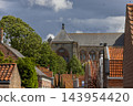 Vertical coastal digital publication of historic church building roof tiles architecture birds sky Veere Zeeland Netherlands European travel maritime heritage commercial 143954420