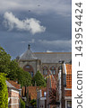 Vertical coastal digital publication of historic church building roof tiles architecture birds sky Veere Zeeland Netherlands European travel maritime heritage commercial 143954424