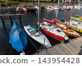 High angle horizontal perspective sailboat harbor marina wooden pier boardwalk moored yachts colorful hulls ropes clear water Veere Zeeland Netherlands European travel commercial 143954428