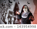 Spooky nun in Halloween costumes by haunted shadow castle 143954998