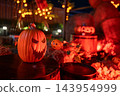 Glowing jack o lantern light up decor in garden at night. 2026 Halloween 143954999