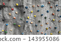 Colorful climbing holds on artificial rock wall 143955086