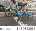 HelloRide public bicycle sharing service parked on a paved walkway next to an decorative stone fence outside the Grand Postal Building. Concept for eco-friendly urban transportation, green travel, and 143956664