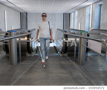 A blind woman rides an escalator in the subway. A blind woman rides an escalator in the subway. 143958572